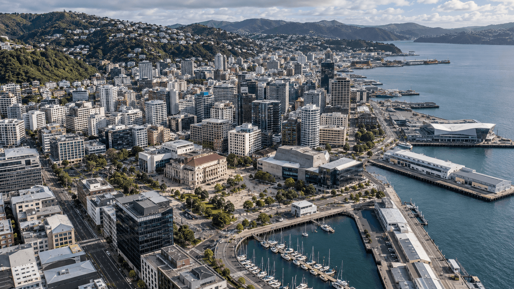 Aerial representative view of Wellington’s compact central city, civic precinct, waterfront, and surrounding hills