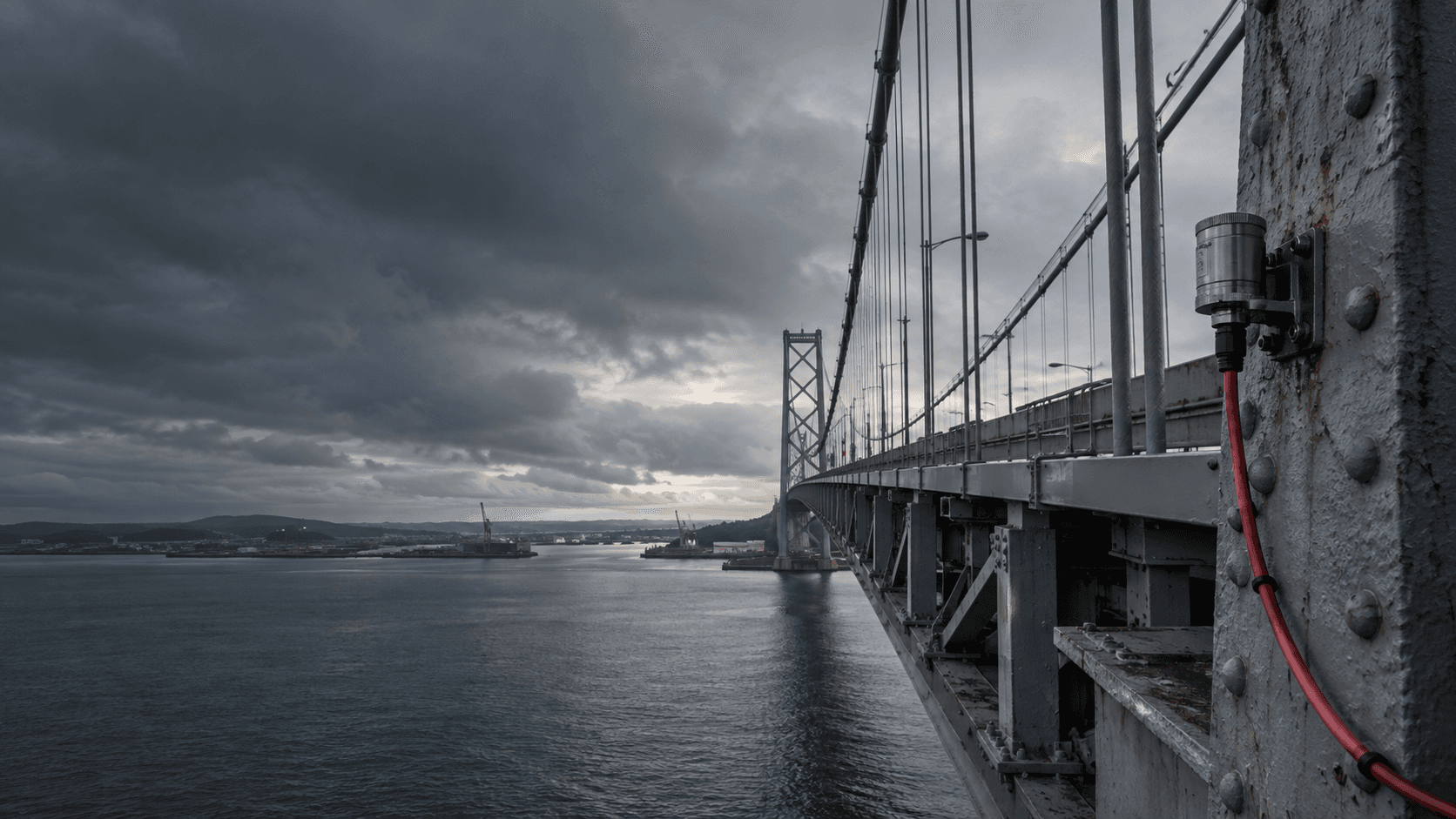 Suspension bridge and a vibration sensor mounted to a steel member